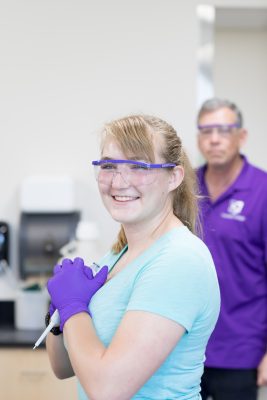 Student smiling in a science lab