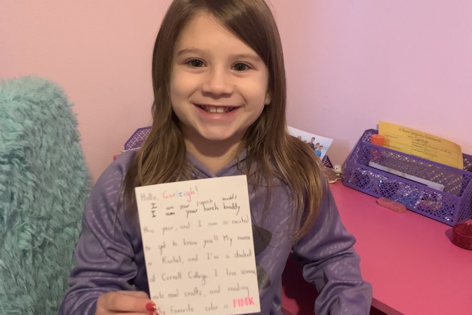 Third grader Carleigh Haugse with a letter from her buddy Rachel Wadkins ‘21