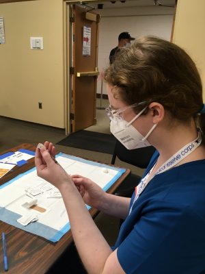 Skye McCormick holding the COVID-19 vaccine