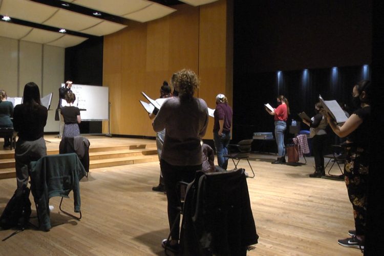 Choir members rehearse for the May 2 concert. 