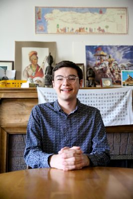 Alex Nelson sits inside Prall House on Cornell's campus. 