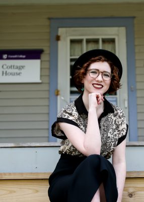 Madeleine Kleckner, Class of 2021, sits on the steps of The Cottage, home to the student organization, TWRG. 