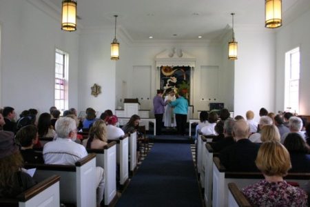 Wedding photo of two people at the altar in Allee Chapel