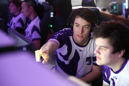 two students sitting in front of esports computer. One points at the screen.