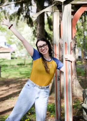 Jenna Makkawy, Class of 2021, stands near the swinging bench by Hanson House. 