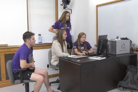 Associate Professor of Kinesiology Krisi Meyer (center) works with (from left) Quinten Howe, Rory Light, and Sydney Hancox.