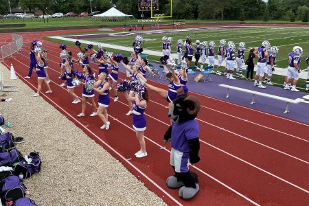 Cheerleaders cheering for the Rams at the first football game of the 21-22 season.