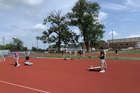 Students play bags during Field Day