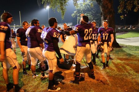 Football players ring the Ash Park victory bell