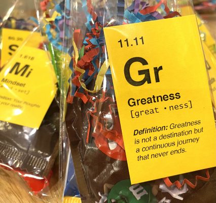 Bags of candy with bright yellow period table-themed cards