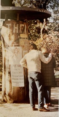 A couple stops to read messages on the original kiosk. 