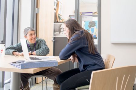 Professor of Biology Marty Condon works with a student outside her office in Russell Science Center.