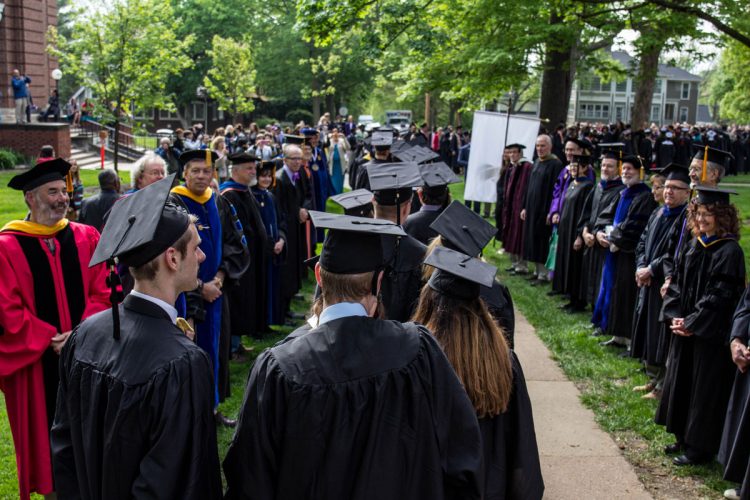 Faculty greet 2016 graduates processing to Commencement through their ranks.