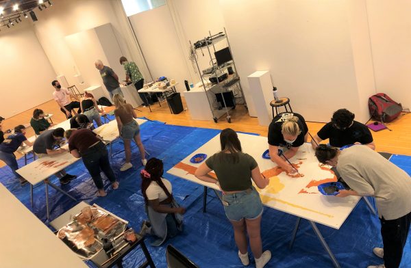 Art and Community classmates work on the mural 