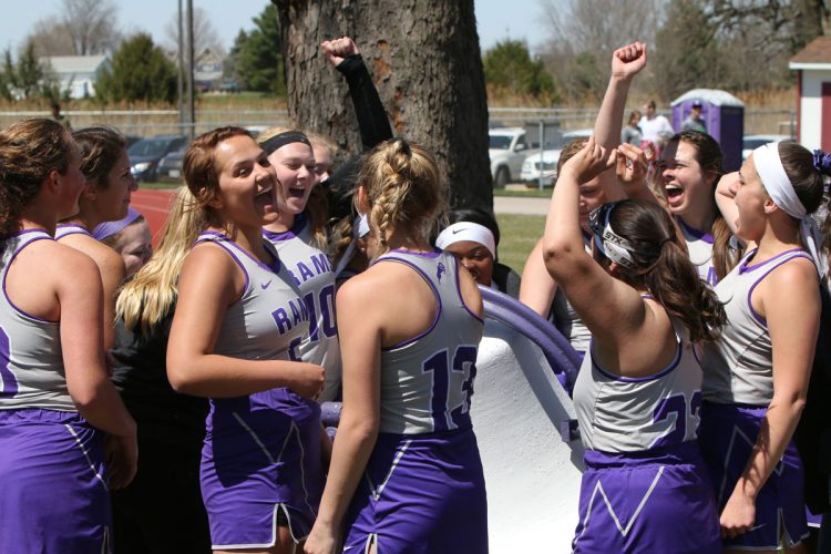 The women’s lacrosse team rings the victory bell in Van Metre Field.