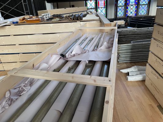 A crate holds several large pipes of Cornell's organ in King Chapel.