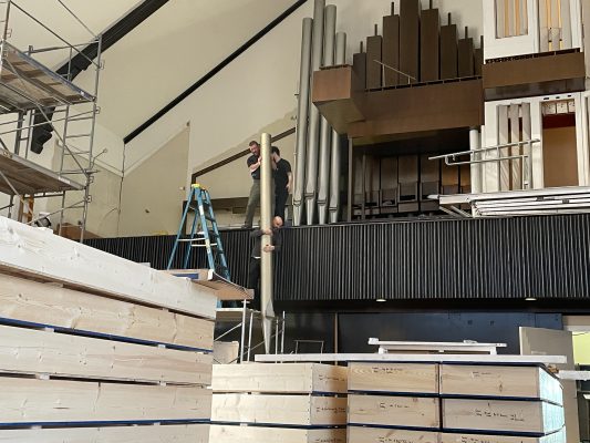 A crew removes a large pipe on the pipe organ in King Chapel ahead of the derecho repairs on the building.