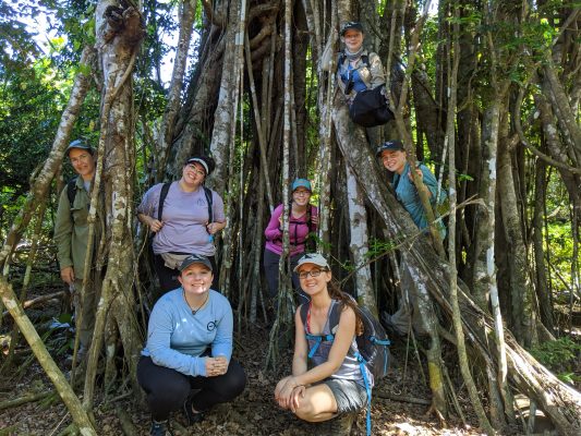 Students standing among trees in the Mariana Islands