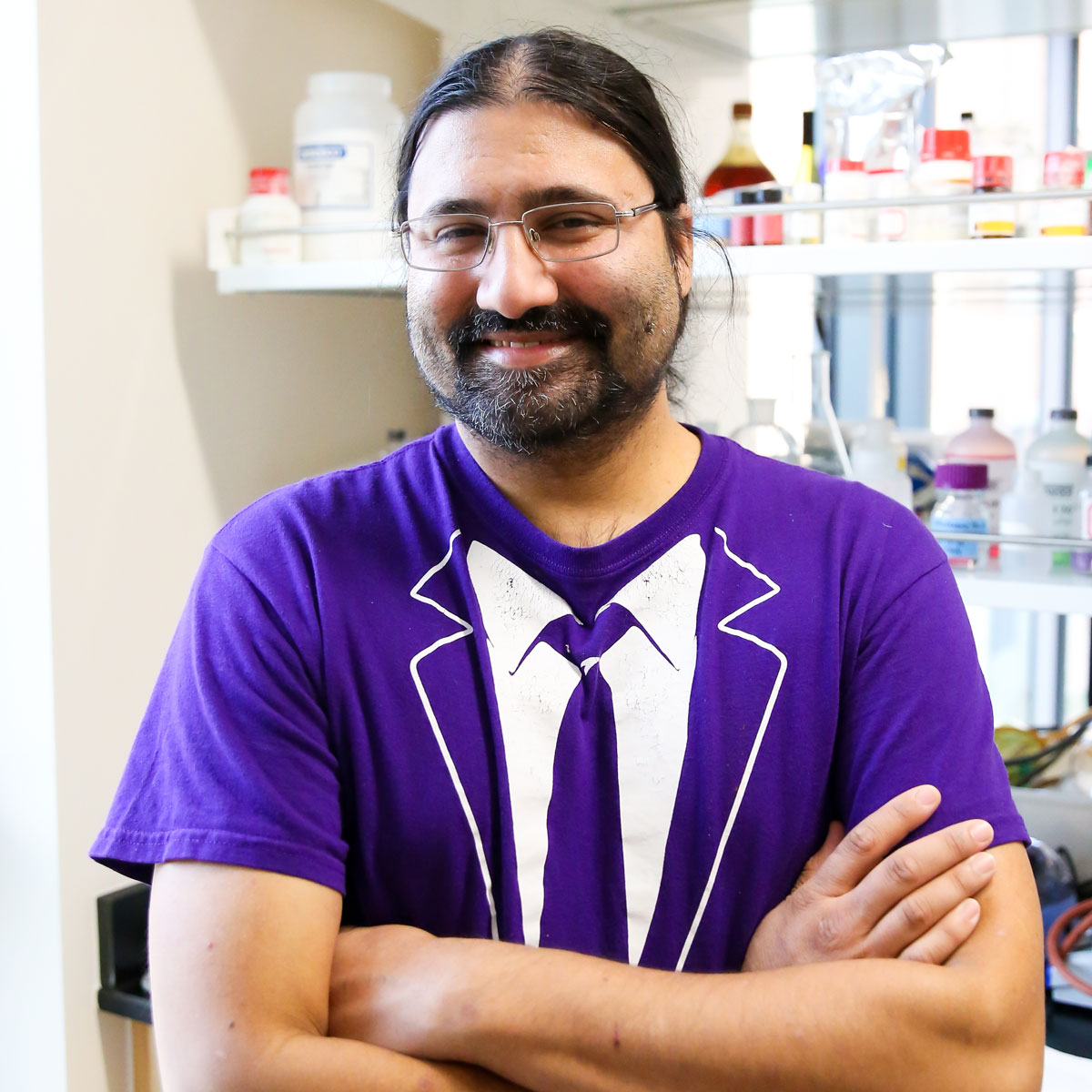 Associate Professor Jai Shanata ’05 wears his “formal” research attire in a Russell Science Center chemistry lab.
