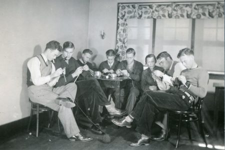 Archive photo of men knitting and smoking at Cornell College for WWII
