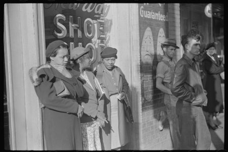 This photo, taken by New Deal photographer Marion Post Wolcott in 1939, shows three domestic workers waiting on Mitchell Street in Atlanta for the early morning street car that will take them to their places of employment in private households. Black passengers routinely faced discrimination from white passengers and drivers on the segregated street cars of Atlanta, Georgia, and elsewhere in the South. Coutesy: Library of Congress, Prints & Photographs Division, Farm Security Administration/Office of War Information Black-and-White Negatives.