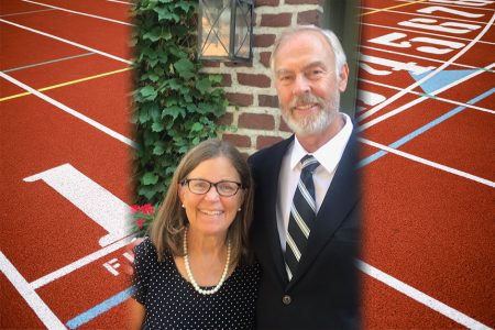 Susan Taylor Spielman '75 and husband Rick Spielman with track in the background
