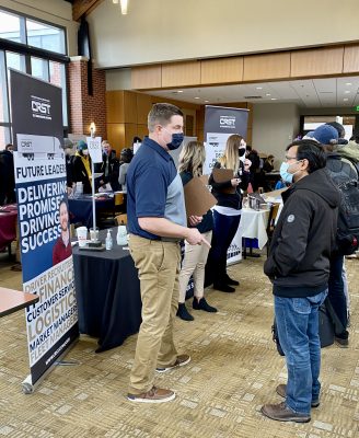 An employer talks with a student during the Job & Internship Expo