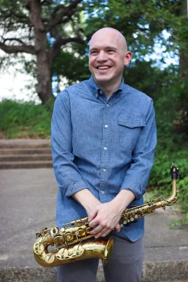 Jim Buennig holding a saxophone
