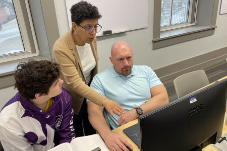 Professor Hejeebu with two students at computers