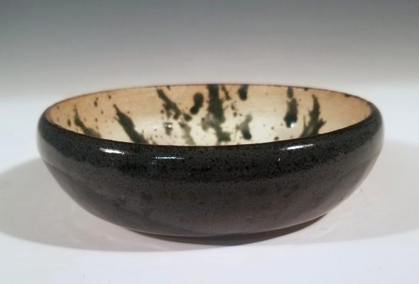 A black and off-white ceramic bowl