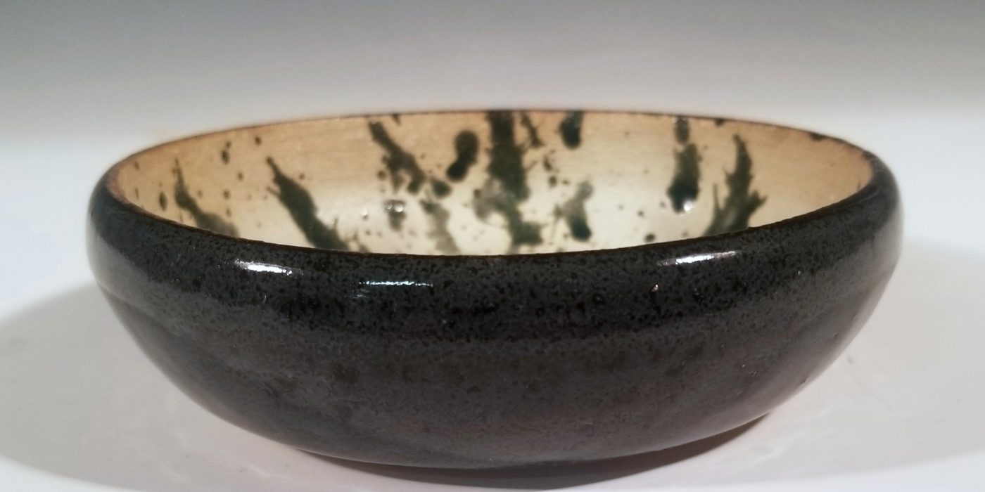 A black and off-white ceramic bowl