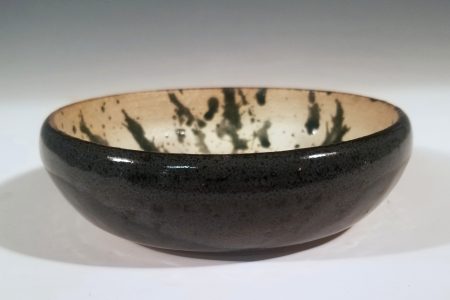 A black and off-white ceramic bowl