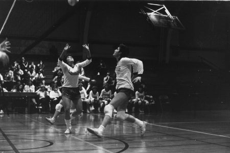 Black-and-white image of a 1986 intercollegiate volleyball match at Cornell.