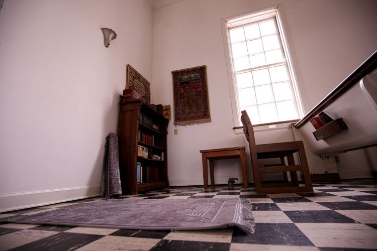 In the northeast corner of Allee Chapel is a qibla wall facing Mecca for Muslim prayer. This space was established by a local imam after two prayer rugs (one on the floor, the other rolled up nearby) were given by the mother of sisters Roshan Iqbal ’00 and Roohi Iqbal ’00. The nearby shelf holds resources to support a variety of traditions including Qurans, a book of common prayer, and Jewish prayer books donated by Temple Judah in Cedar Rapids. The chapel is open daily during the school year for individual meditation and group worship.