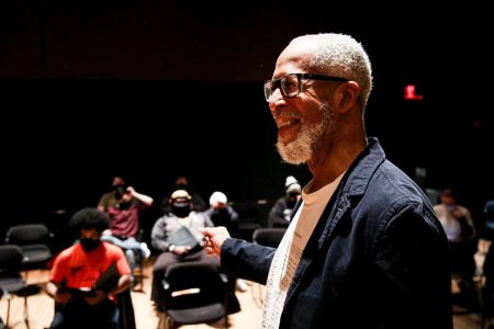 Charles Thomas Hayes '77 smiles at the Cornell choir singers during a rehearsal in Ringer Recital Studio.