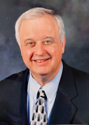 Attorney Gilbert Davis '64 headshot in suit.