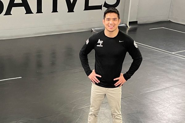 Chris Heilman '08 stands on the wrestling mat at the U.S. Air Force Academy