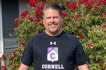 Jeff Maples '89 today in running gear standing outdoors in front of a blooming bush