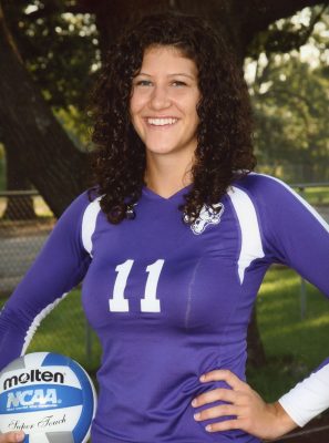 All-American Kathleen O’Connor ’13 standing outdoors holding a volleyball, as a Cornell College student-athlete.