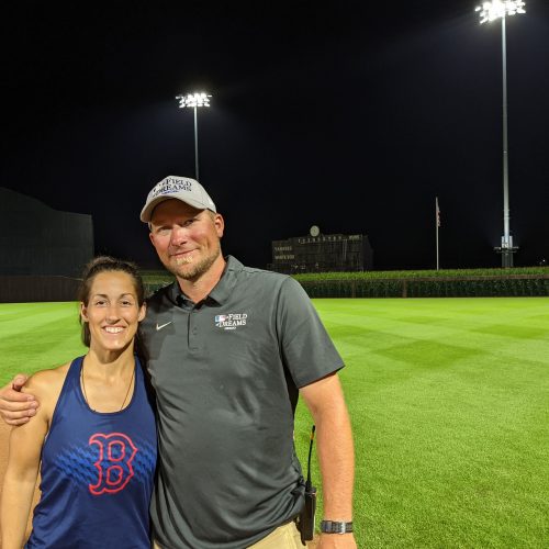 Elizabeth and Kevin Moses ’04 at the Field of Dreams in Dyersville, Iowa. Moses collects baseball hats (his Field of Dreams hat pictured in the photo) from the ballparks he works on. 