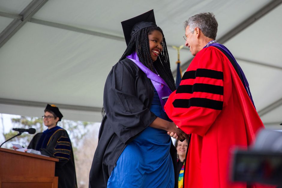 Lauren Williams ’22 shakes hands with President Jonathan Brand after her name is read at Commencement.