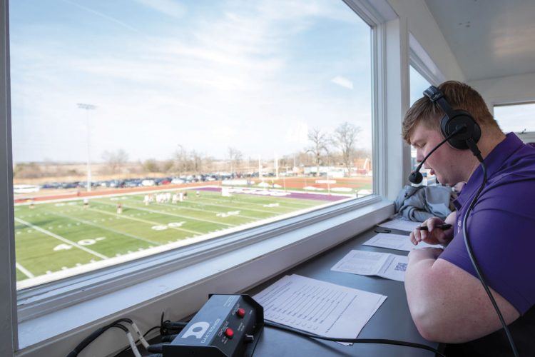 The press box at Van Metre Field at Ash Park was built in 1991 by Steve Miller ’65, Jim Wallace ’68, and Doug Van Metre ’50, and renovated in 2018. It is abuzz with gameday personnel for home football, track and field, and lacrosse competitions. Sports information staff, media, scoreboard and timing/clock operators, and an announcer (in this case, Zach Perry ’24) occupy the main level. The upper level includes coaches’ booths on the ends, with the center section used by home and visiting videographers. Photo by Ray Borchert ’24.