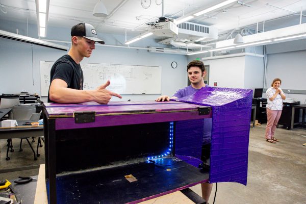 Senior Daniel Shaw (right) and sophomore Tanner Sanders work on their wind tunnel during CSRI 2022.
