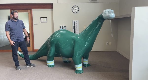 Facilities Operations Manager Luke Fischer with Cornell's new dinosaur