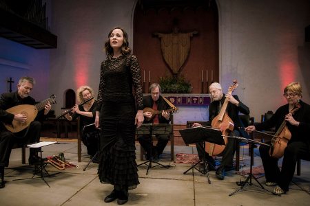 The Baltimore Consort museums perform on stage with their singer standing in front.