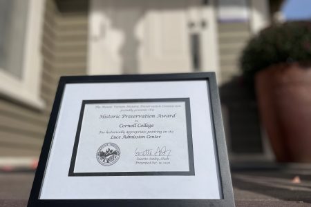 Picture of a framed award on the steps of Luce House.