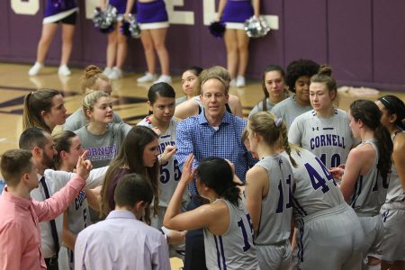 Women’s Basketball Head Coach Brent Brase ’90, assistant coaches, and the team during a time out.