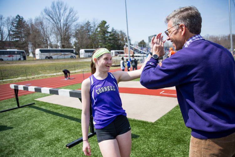 President Brand high-fives Shelby Williams ’21 at a track meet on campus.