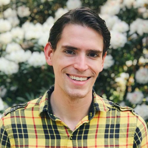 Portrait of Jonathan Frazier '12 outdoors in plaid shirt