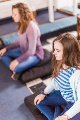 Students practice meditation in Allee Chapel,